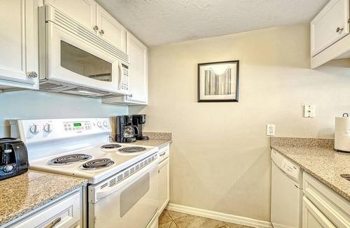 Longboat Key Apartment | LaPlaya 101E-Relax on your private lanai under the palms!