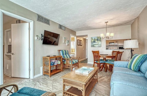 Longboat Key Apartment | LaPlaya 101E-Relax on your private lanai under the palms!