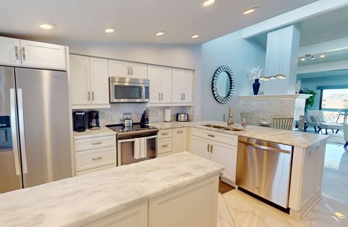 Capri Isle Condo | Luxurious Coastal Condo with Waterway Views, Pool, Balcony, and Steps to Treasure Island Beach.