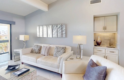 Capri Isle Condo | Luxurious Coastal Condo with Waterway Views, Pool, Balcony, and Steps to Treasure Island Beach.