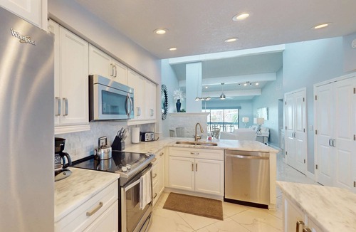 Capri Isle Condo | Luxurious Coastal Condo with Waterway Views, Pool, Balcony, and Steps to Treasure Island Beach.