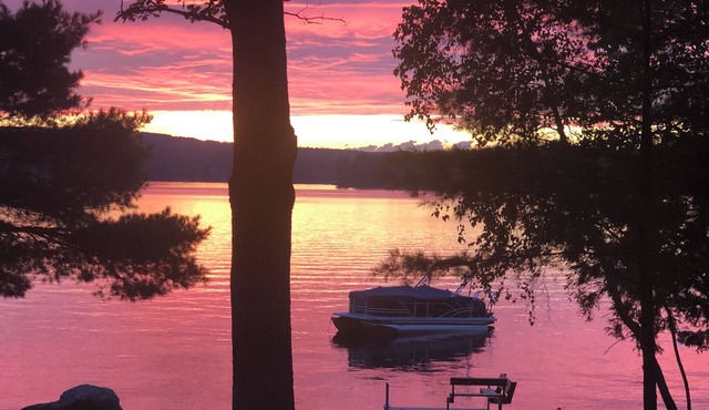 Relax in the glow of a campfire at this waterfront cottage on Thompson Lake