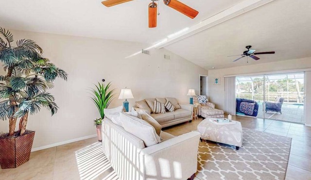Waterfront home with an enclosed pool, outdoor kitchen, and grill - dog-friendly